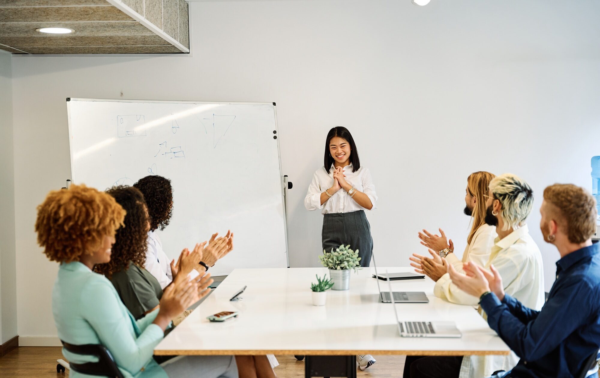 Coworkers applauding the presentation of a project of a colleague